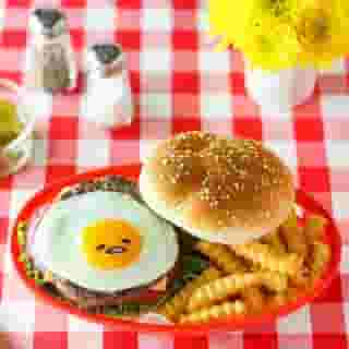 It's #NationalHamburgerDay! 🍔 Take this diner classic to the next level with your favorite lazy egg. Visit the link in bio to find this @gudetama burger recipe by @thirstyfortea on Sweet Happy News! #gudetama