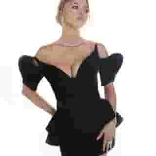 Sydney Sweeney wore a vintage dark green 1981 Mugler "Vampire" dress to the Hollywood Critics Association TV Awards over the weekend. "Syd really envisioned a vintage dress for this event and after lots of research we found this 1981 Mugler from @newyorkvintageinc and then paired it w some Jimmy Choos," the star's stylist @mollyddickson said on Instagram. ‘The White Lotus’ took home 5 awards on the evening, hit the link in bio to read our thoughts on the show’s first season 📸 @sarahkrickphotography via @sydney_sweeney, New Vision/Getty