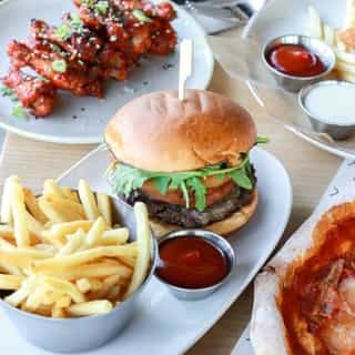 THE TRUFFLE ONION RING BURGER | aka our current obsession 😍⁠
⁠
Stacked high with a 100% Canadian beef patty, truffle gouda, beer battered onion rings, arugula, and black garlic truffle aioli - this burger packs a serious punch!⁠
⁠
Check out the link in our bio to order yours for pickup.⁠